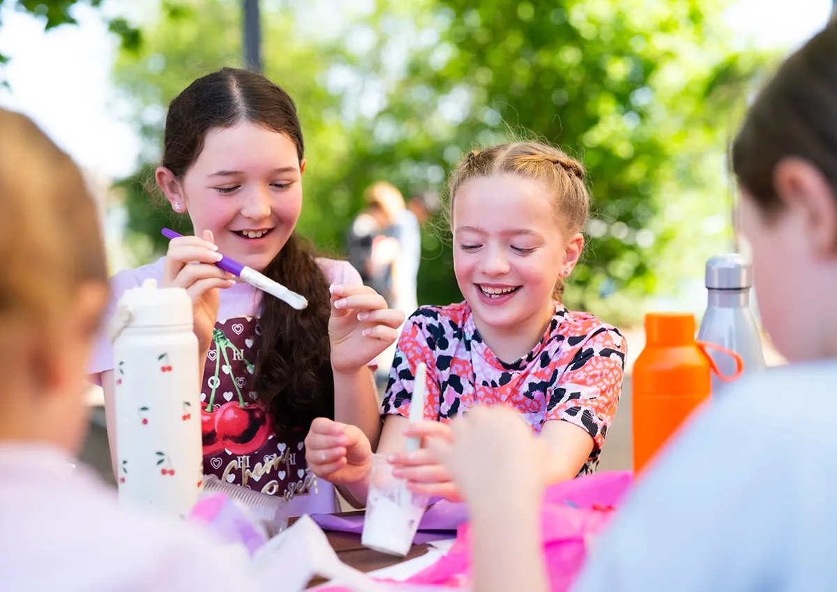 Children doing outdoor crafts during Braintree Holiday Camp at St Michael's