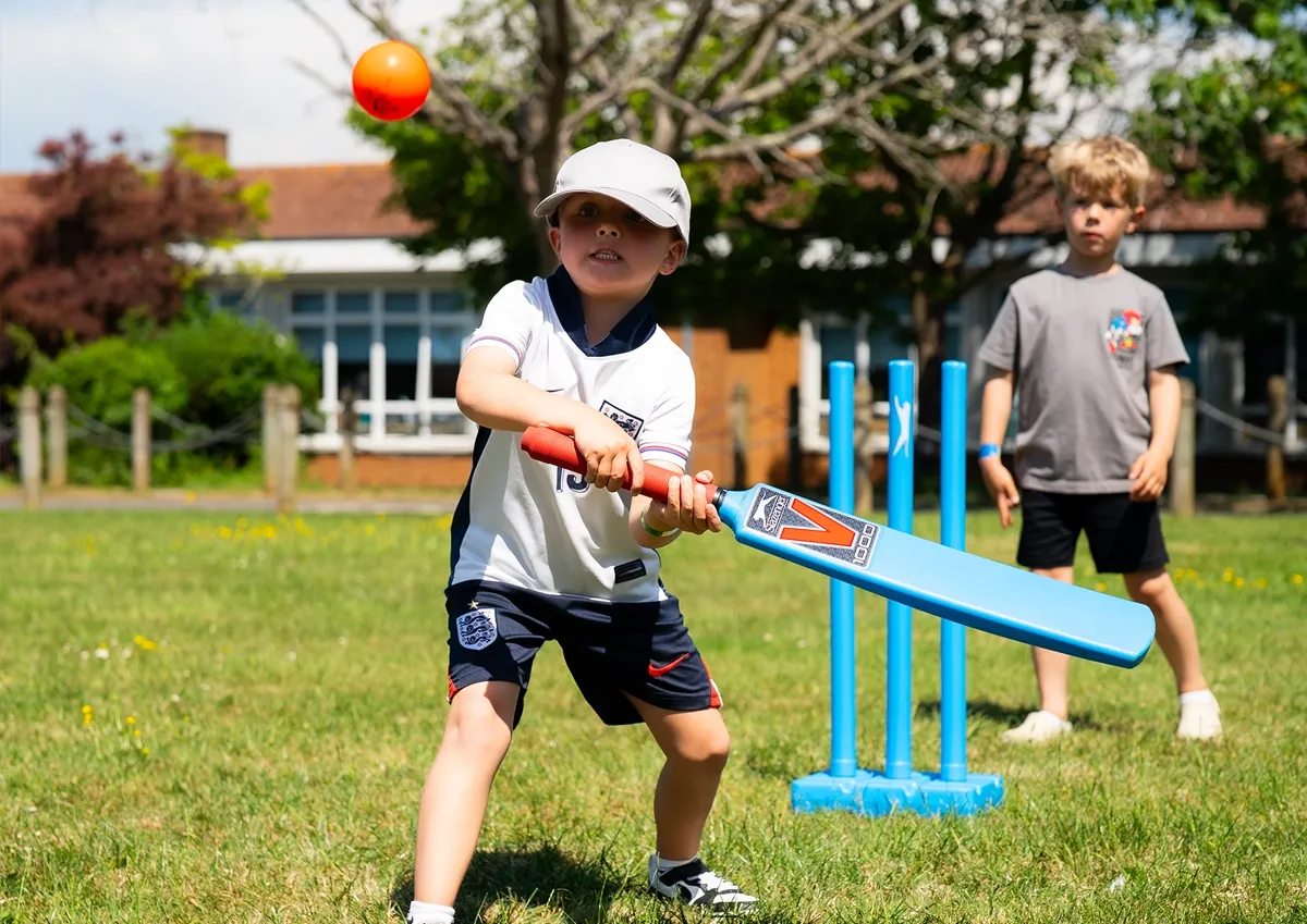 Ware Holiday Camp outdoor cricket activity at Christ Church Child playing cricket outdoors during Ware Holiday Camp at Christ Church