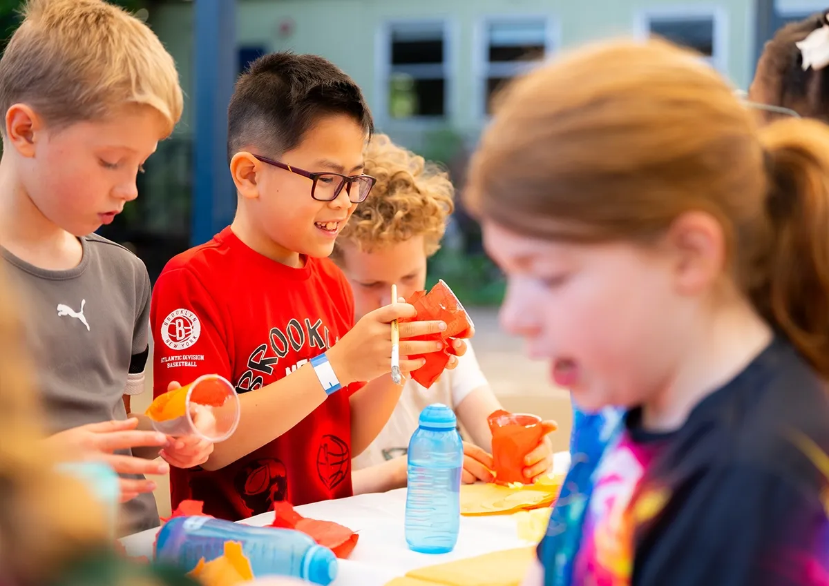 Children making crafts during Warlingham Holiday Camp at Warlingham School