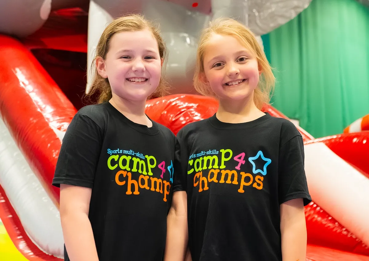 Children smiling in Camp 4 Champs shirts for Southend Holiday Camp